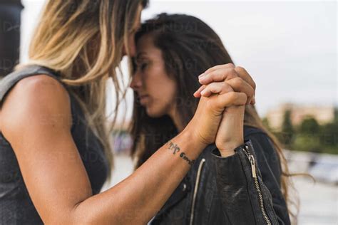 Affectionate Lesbian Couple Holding Hands Outdoors Stock Photo
