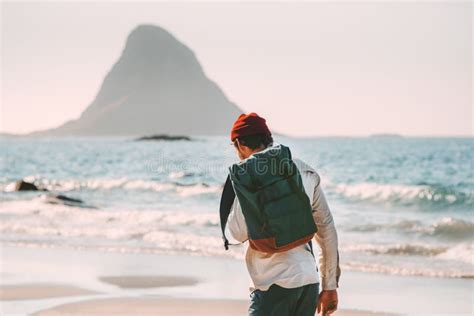 Man Backpacker Walking Alone On Sea Beach Solo Traveling Stock Photo