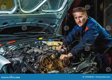 Mechanic With Wrench Working And Repair Car Engine In Car Service