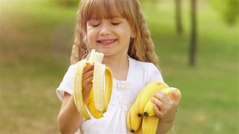 Girl Eating A Banana And Smiles Thumbs Up Stock Footage Video 2494457 Shutterstock