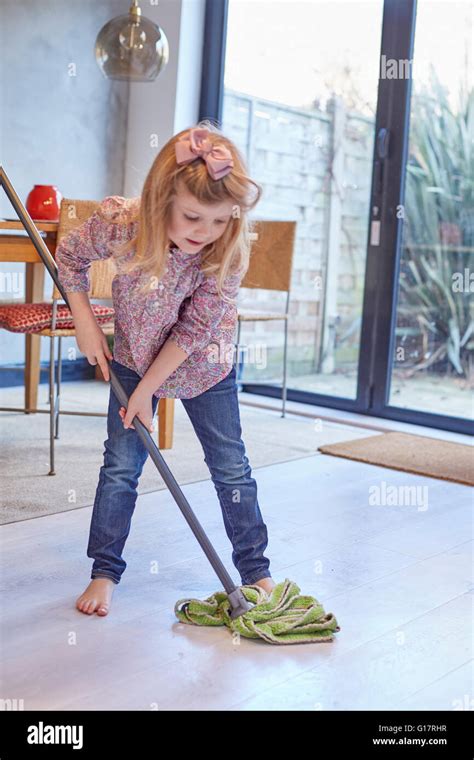 Girl Mopping Dining Room Floor Stock Photo Alamy