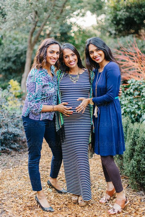 Beautiful Sisters Touching The Pregnant Belly Of Their Little Sister by ...