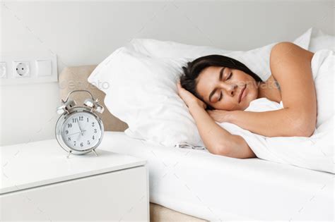 Portrait Of Beautiful Young Woman Sleeping In Bed At Bedroom Wi Stock