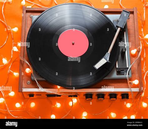 Retro 80s Vinyl Player With Bright Glowing Garlands On Orange