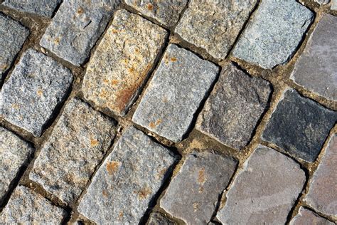 The Texture Of The Stone Pavement Background Of Granite Cobblestone