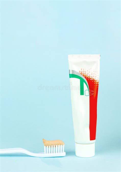 New Toothbrush With Toothpaste Close Up On A Blue Background