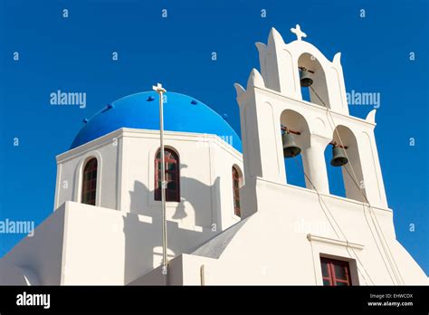 A White Church With A Blue Roof Seen In Oia Santorin Greece Stock