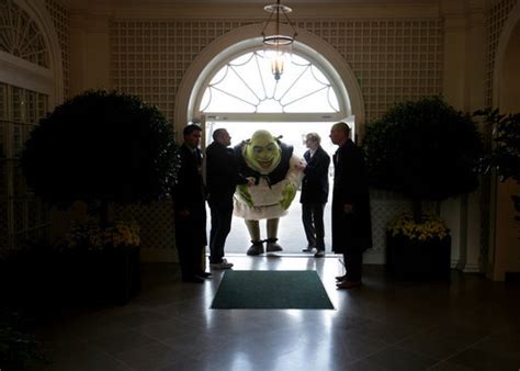 Shrek Receives Some Assistance As He Ducks Entering The Palm Room Of