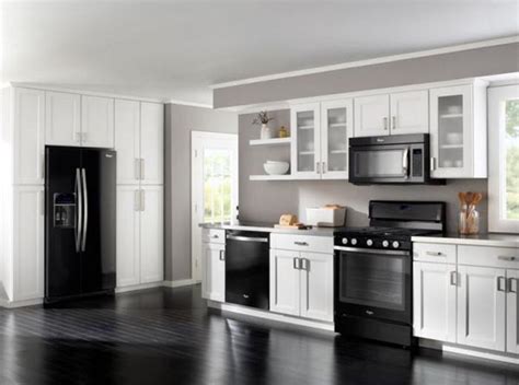 Stainless steel adds a modern touch to a traditional kitchen. Decorating around black appliances