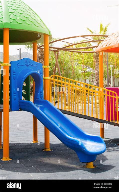 Colorful Children Playground Activities In Public Park Surrounded By