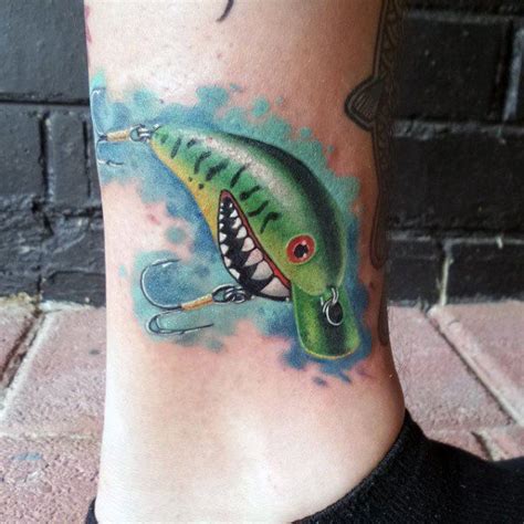 A Tattoo On The Leg Of A Person With A Green Fish