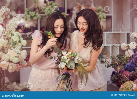 Beautiful Asian Women Florists Happy Working In Flower Store With A Lot Of Spring Flowers Stock