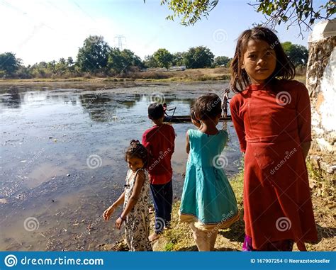 An Indian Village Girl Standing Around Water Lake With Friends