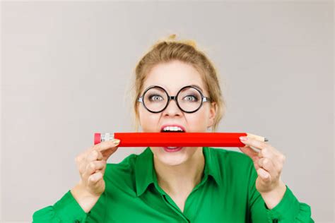 Woman Chewing On Pencil Stock Photos Pictures And Royalty Free Images