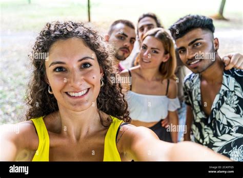 Multiethnic Group Of Millennial Friends Take A Selfie Outdoors Stock