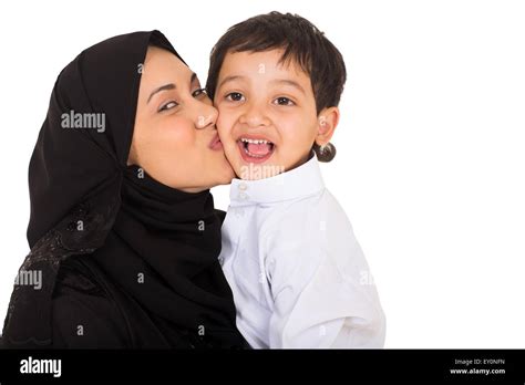 Beautiful Young Muslim Mother Kissing Her Son On White Background Stock