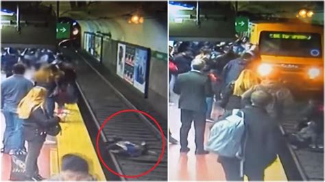 Woman Almost Gets Run Over By Train After Man Faints And Knocks Her On Tracks Chilling Video