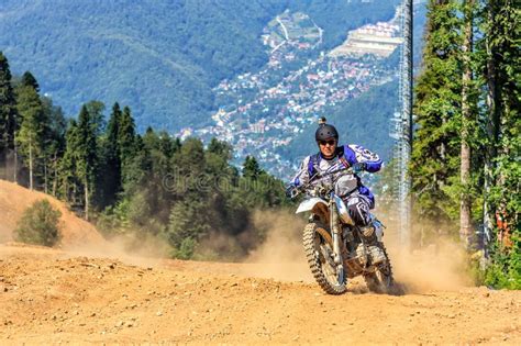 Enduro Motorbike Racer Overcomes Obstacle On Off Road Terrain Track At