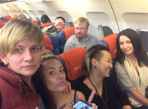 lesbian couple sat by anti gay russian politician pose for selfie kissing in front of him