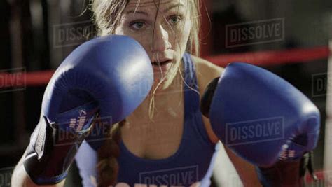 Close Up Of Female Boxer In Boxing Gloves Standing In Boxing Ring