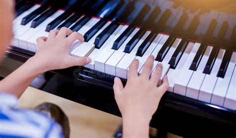 Selective Focus To Kid Fingers And Piano Key To Play The Piano Stock