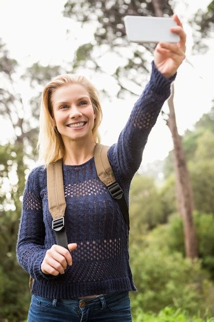 Premium Photo Smiling Female Hiker Taking A Selfie