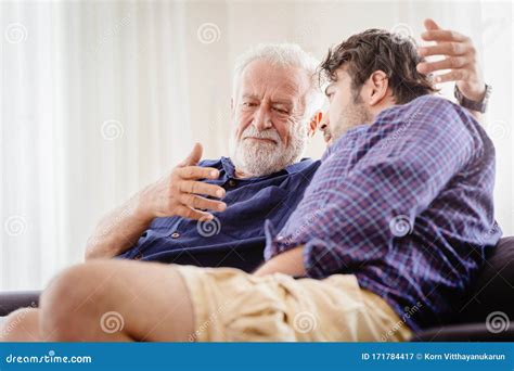 Old Man Serious Discussion With Younger Man Indoor Grand Father