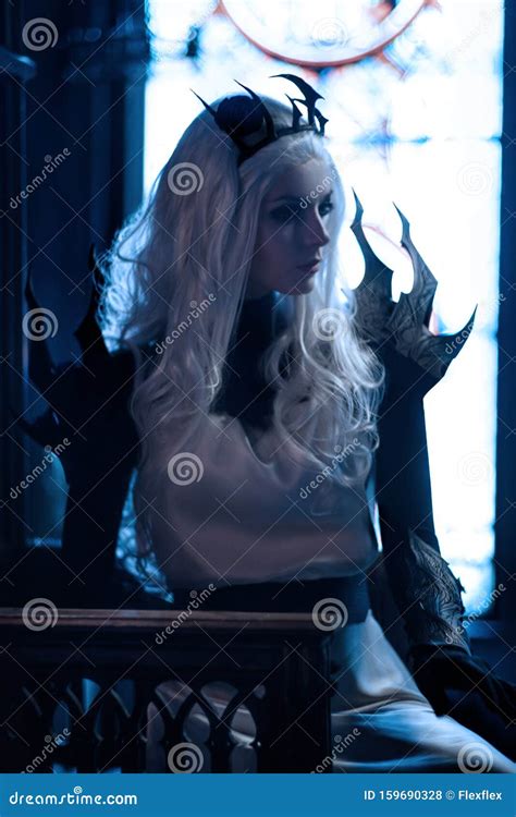 Attractive Blonde Woman In Fantasy Costume Of Dark Queen Stock Photo