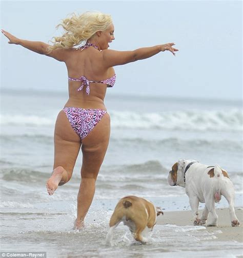 Coco S Dangerous Curves Threaten To Spill Out Of Her Flimsy Swimsuit As She Jogs Along The Beach