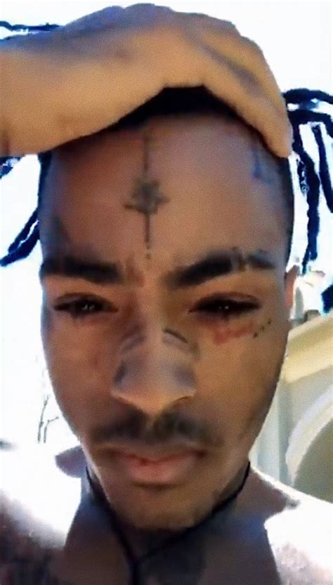 A Man With Dreadlocks And A Cross On His Forehead