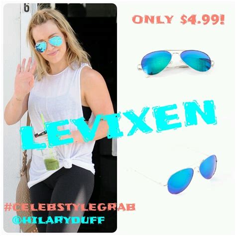 A Woman In White Shirt And Blue Sunglasses With The Words Revxen On It