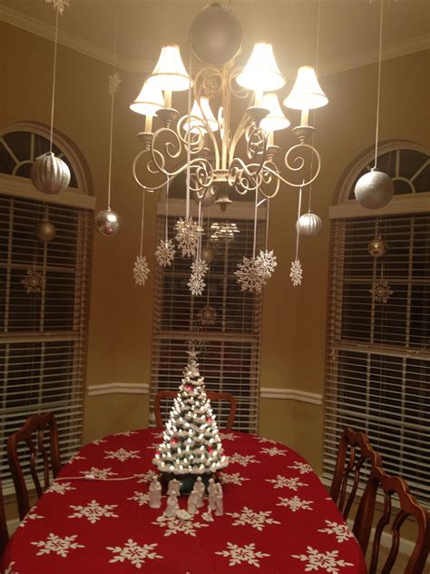 Hang several of these snowflake lines onto a curtain rod and voila. Hang ornaments and snowflakes from the ceiling and ...