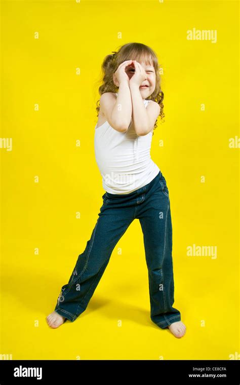 Cheerful Girl Dances On A Yellow Background Stock Photo Alamy