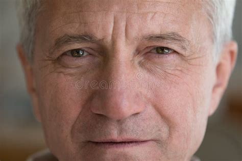 Face Of Serious Mature Elder Man With Brown Eyes Wrinkles Stock Photo