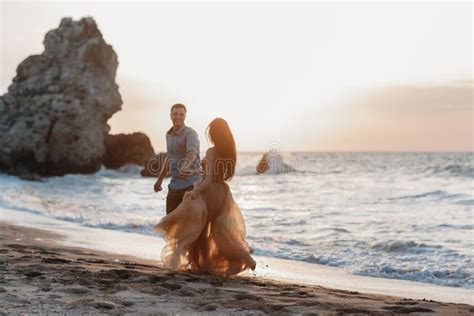 Happy Couple In Love During Honeymoon On A Rocky Beach Near The Blue Ocean Stock Image Image