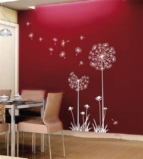 A Dining Room With A Red Wall And White Dandelion Decals On The Walls