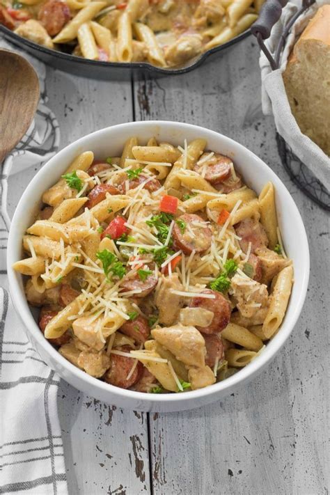 Once the meat and veggies are stirred into the sauce, add the pasta. Cajun Chicken and Sausage Pasta - This Ole Mom