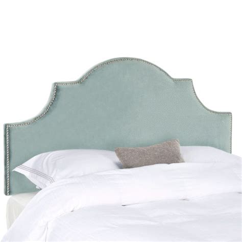 An Upholstered Headboard On A Bed With White Linens And Gray Pillows