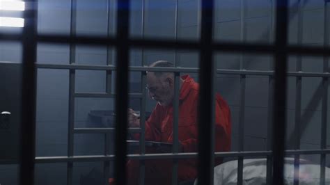 Elderly Prisoner In Orange Uniform Sits In Stock Footage SBV Storyblocks