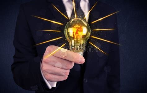 Business Person Holding An Electric Light Bulb Stock Photo Image Of