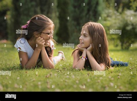 Two Girls Talking And Smiling Stock Photo Alamy