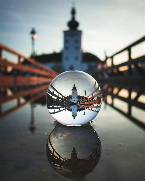 A Nice Clear Reflection Shining Down On A Puddle Through A Lensball
