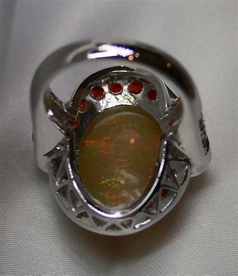 Ladies Solid Crystal Opal 18k White Gold Ring Surrounded By Rubies And