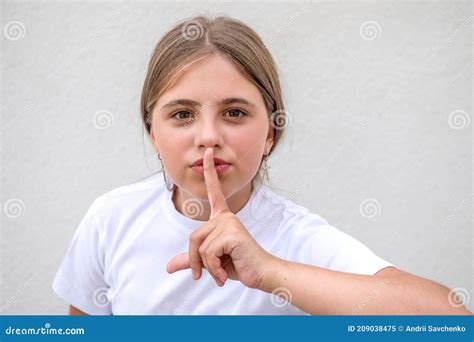 Girl Put Her Finger On Mouth Keep Silent Concept Candid Portrait Of