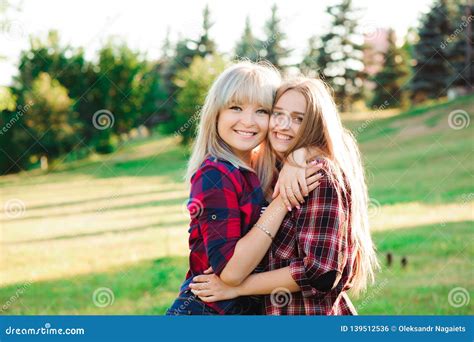 Girl Hugging Her Best Friend In The Park Stock Photo Image Of