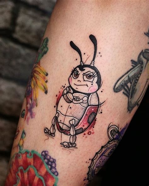 An Arm With Tattoos On It That Has A Bug In The Center And Other Bugs