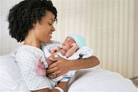 Smiling Black Mother Holding Newborn Baby In Hospital Stock Photo