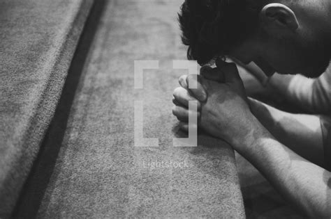 A Man Kneeling In Prayer At The Altar — Photo — Lightstock