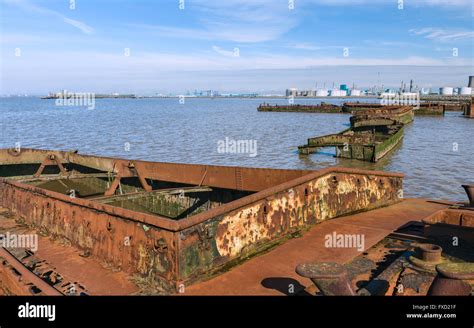 Rusting Obsolete And Abandoned River Boats Beached On The Mud Banks