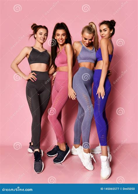 Full Length Portrait Of Four Sport Girls International Friends Posing